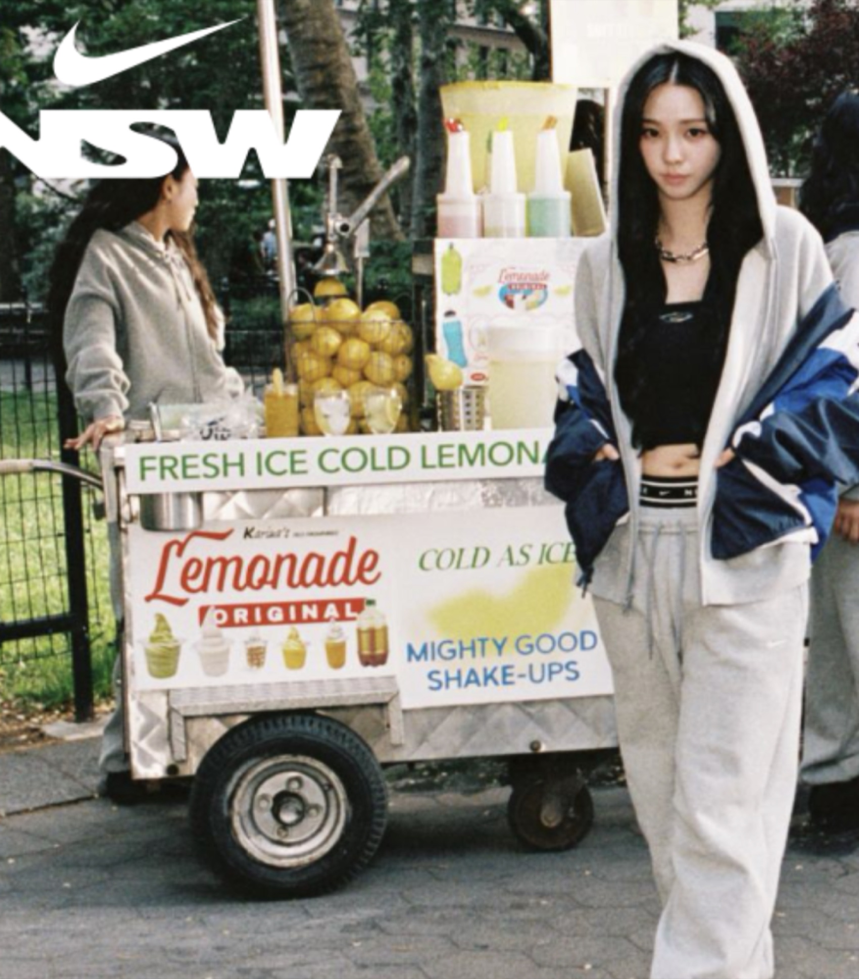 Talent in Nike Studio Fleece beside the branded lemonade cart