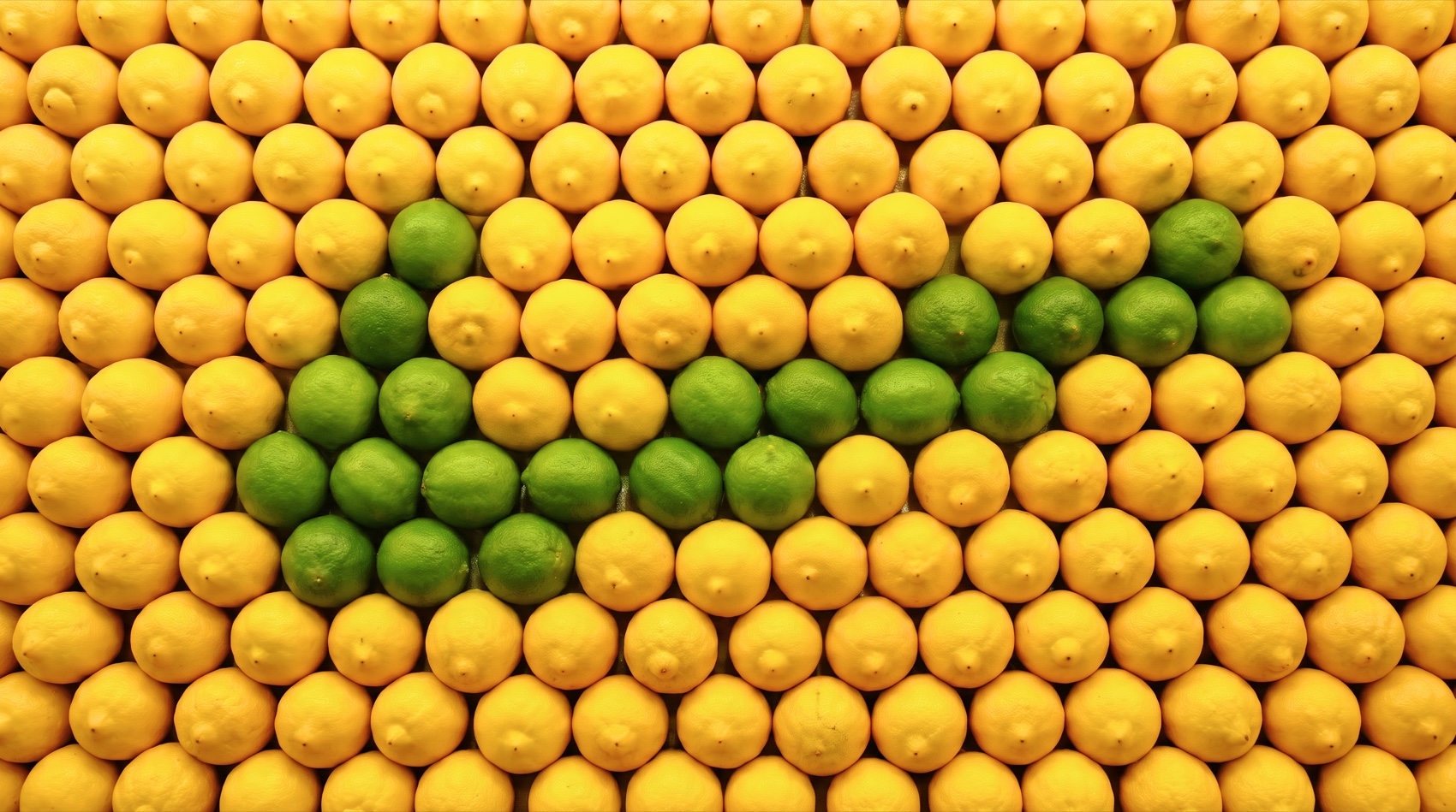 Nike Swoosh laid out in limes against a field of lemons